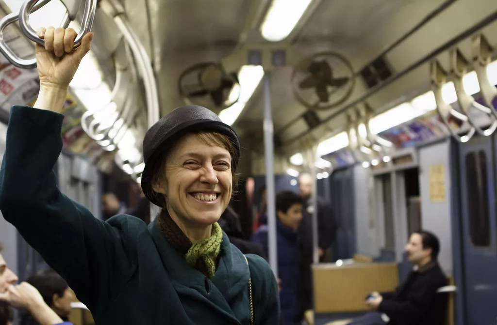 Smiling woman on New York subway